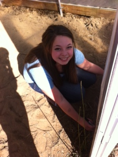 Camille checks out the measurements for the seed rows. 