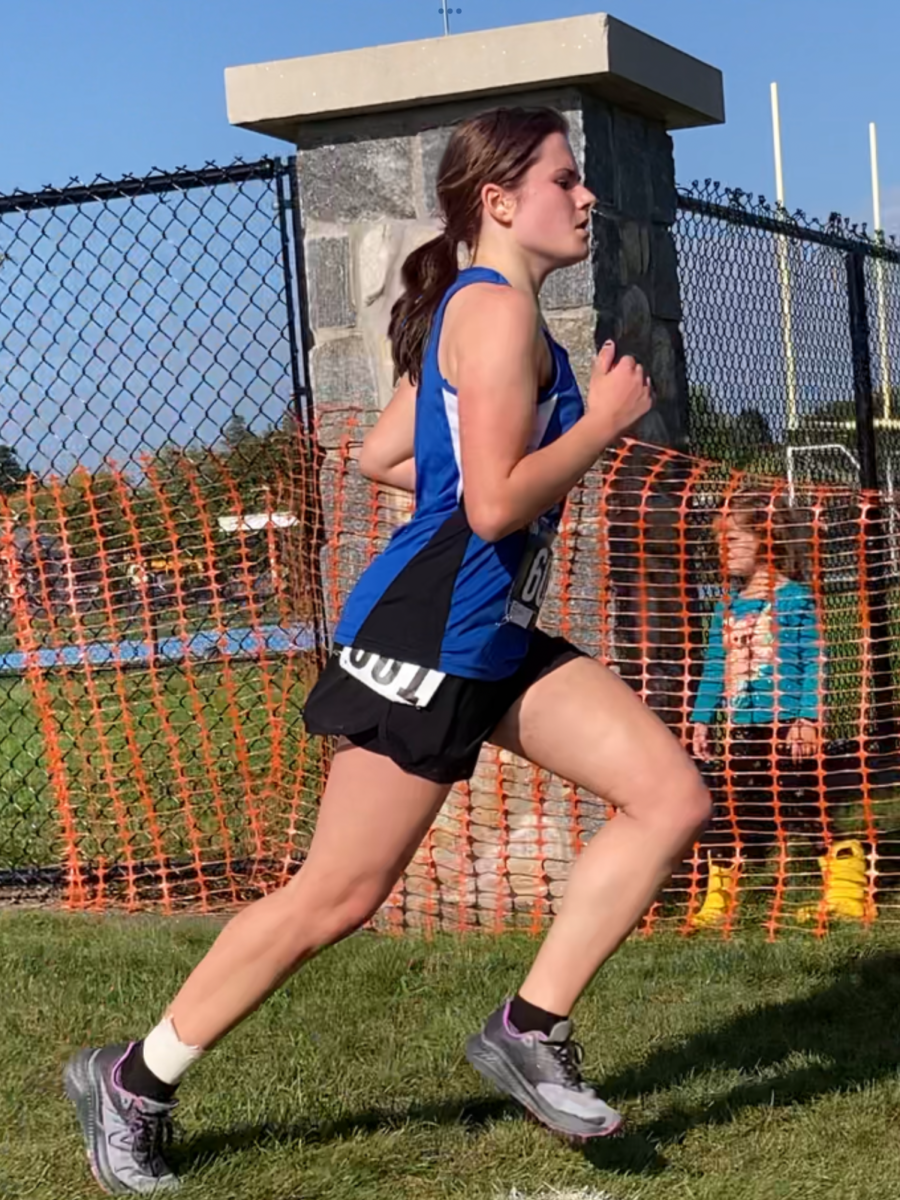 Mikaela finishing at the E.J Herman invitational 